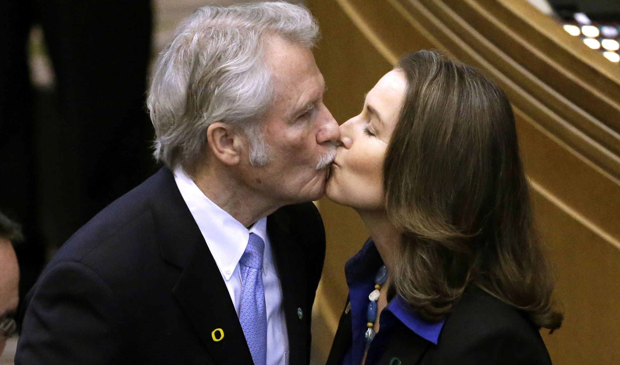 In this Jan. 12, 2015 file photo, Oregon Gov. John Kitzhaber kisses fiancee, Cylvia Hayes, after he is sworn in for an unprecedented fourth term as Governor in Salem, Ore.  (AP Photo/Don Ryan)