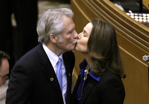 In this Jan. 12, 2015 file photo, Oregon Gov. John Kitzhaber kisses fiancee, Cylvia Hayes, after he is sworn in for an unprecedented fourth term as Governor in Salem, Ore.  (AP Photo/Don Ryan)