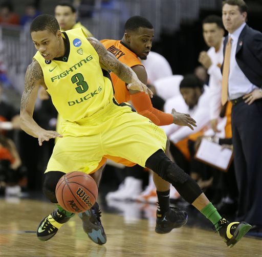 Oregon guard Joseph Young (3) drives around Oklahoma State guard Anthony Hickey Jr. during the first half of an NCAA tournament college basketball game in the Round of 64, Friday, March 20, 2015, in Omaha, Neb. (AP Photo/Charlie Neibergall)