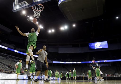 Oregon center Michael Chandler, left, drives to the basket during practice for an NCAA college basketball tournament second round game, Thursday, March 19, 2015, in Omaha, Neb. Oregon plays Oklahoma State on Friday. (AP Photo/Charlie Neibergall)