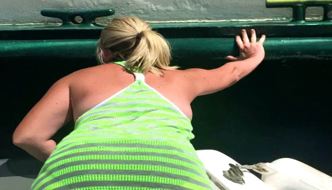 Rachel Fisher used her hands and feet to push the Portland Spirit away from her family's boat. (YouTube)