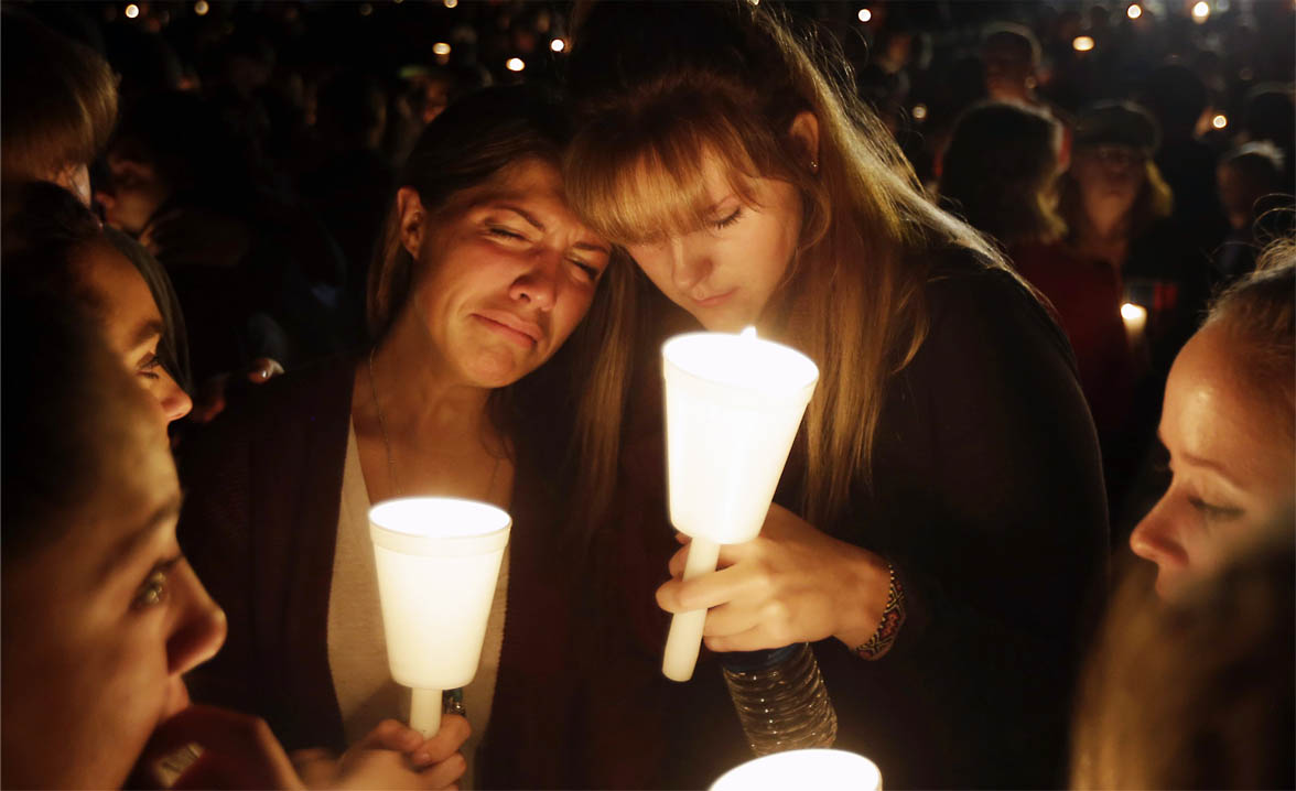 Kristen Sterner, left, and Carrissa Welding, both students of Umpqua Community College, embrace each other during a candle light vigil in Roseburg, Ore. (AP Photo/Rich Pedroncelli)