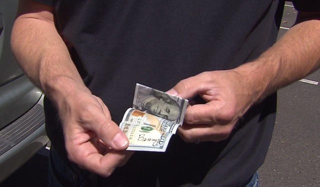 Brian Stone found a $100 'Benny' bill on the front seat of his car in Salem, July 26, 2016 (KOIN)