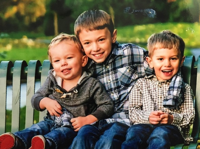 Connor Rezewski (center) with his brothers in an undated courtesy photo provided June 20, 2017