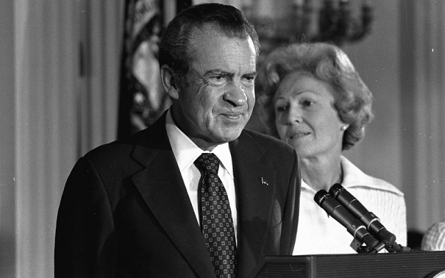 In this Aug. 9, 1974 black-and-white file photo, President Richard M. Nixon and his wife Pat Nixon are shown standing together in the East Room of the White House in Washington. (AP Photo/Charlie Harrity, File)