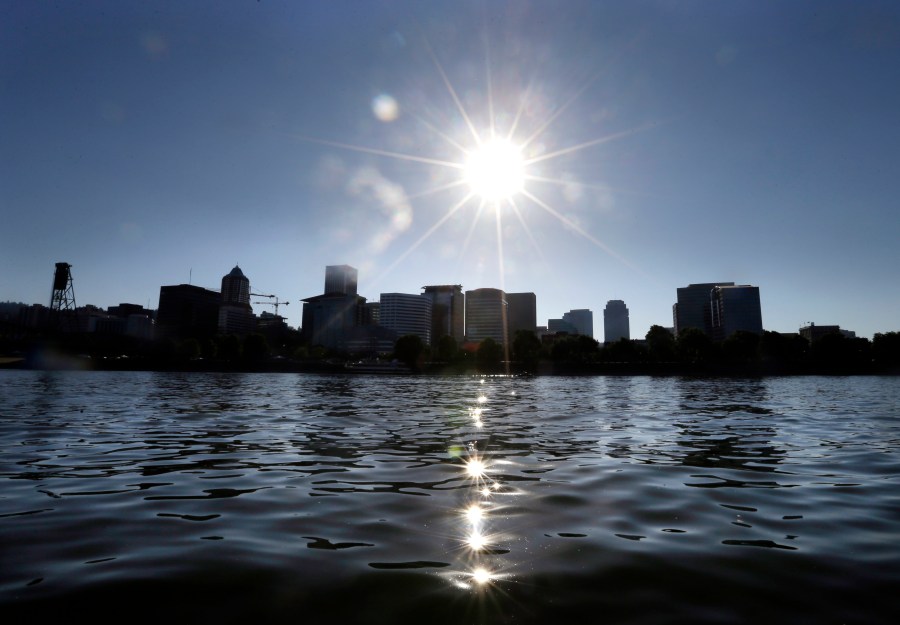 In this Thursday, July 6, 2017 photo, late afternoon sun sparkles off the Willamette River through downtown Portland, Ore. (AP Photo/Don Ryan)