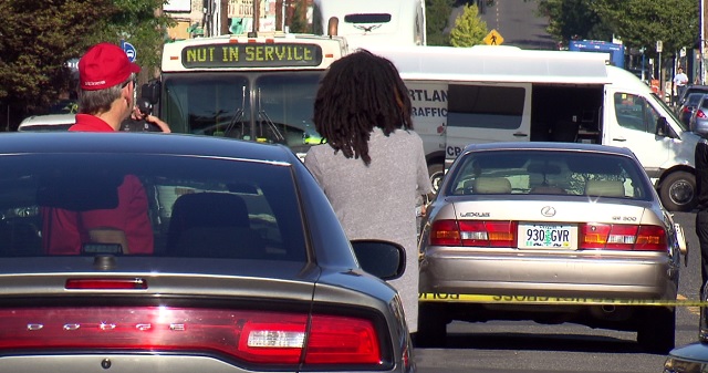 Abdulrahman Noorah (gray sweater) at the scene of a crash that killed 15-year-old Fallon Smart, August 19, 2016 (KOIN)