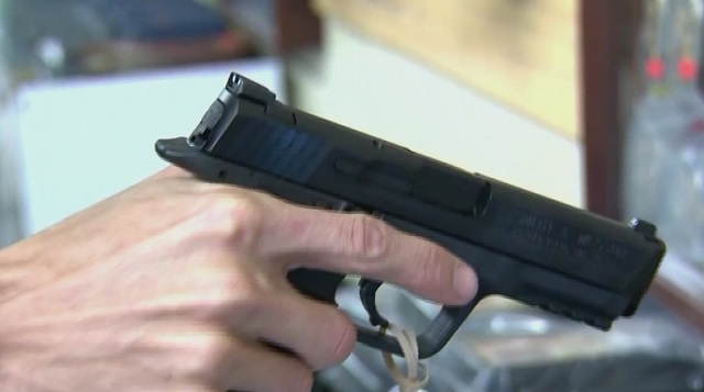 A man holds a gun at a gun store (KOIN, file)