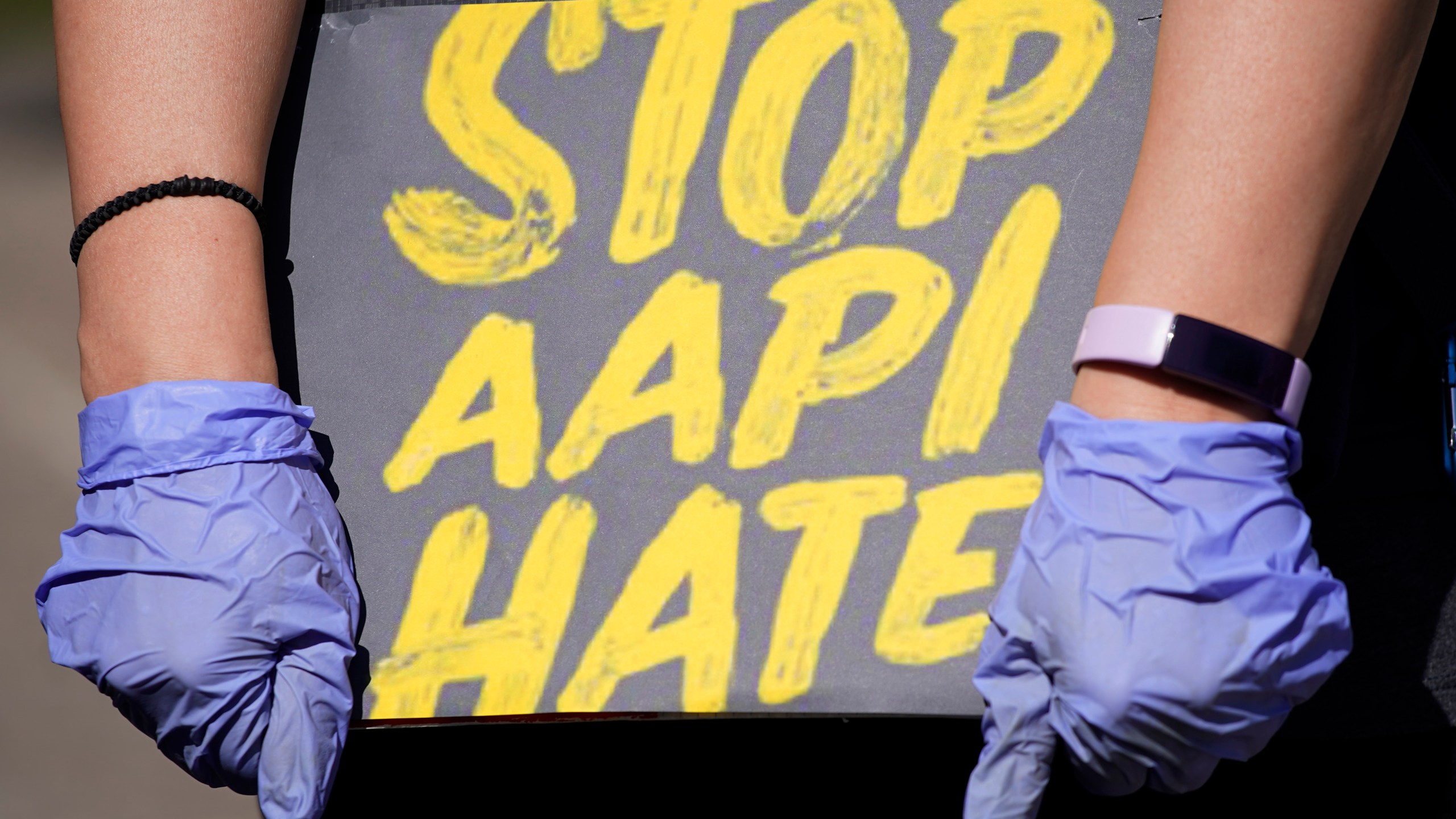 ILE - In this March 20, 2021, file photo, woman holds a sign and attends a rally to support stop AAPI (Asian Americans and Pacific Islanders) hate at the Logan Square Monument in Chicago. After more than a year filled with attacks on Asian Americans unfairly blamed for the coronavirus, a majority of Americans across racial and ethnic groups believe anti-Asian American discrimination has worsened over the last year. A poll from the The Associated Press-NORC Center for Public Affairs Research finds nearly half of Americans believe Asian Americans encounter "a great deal" or "quite a lot" of discrimination. (AP Photo/Nam Y. Huh, File)