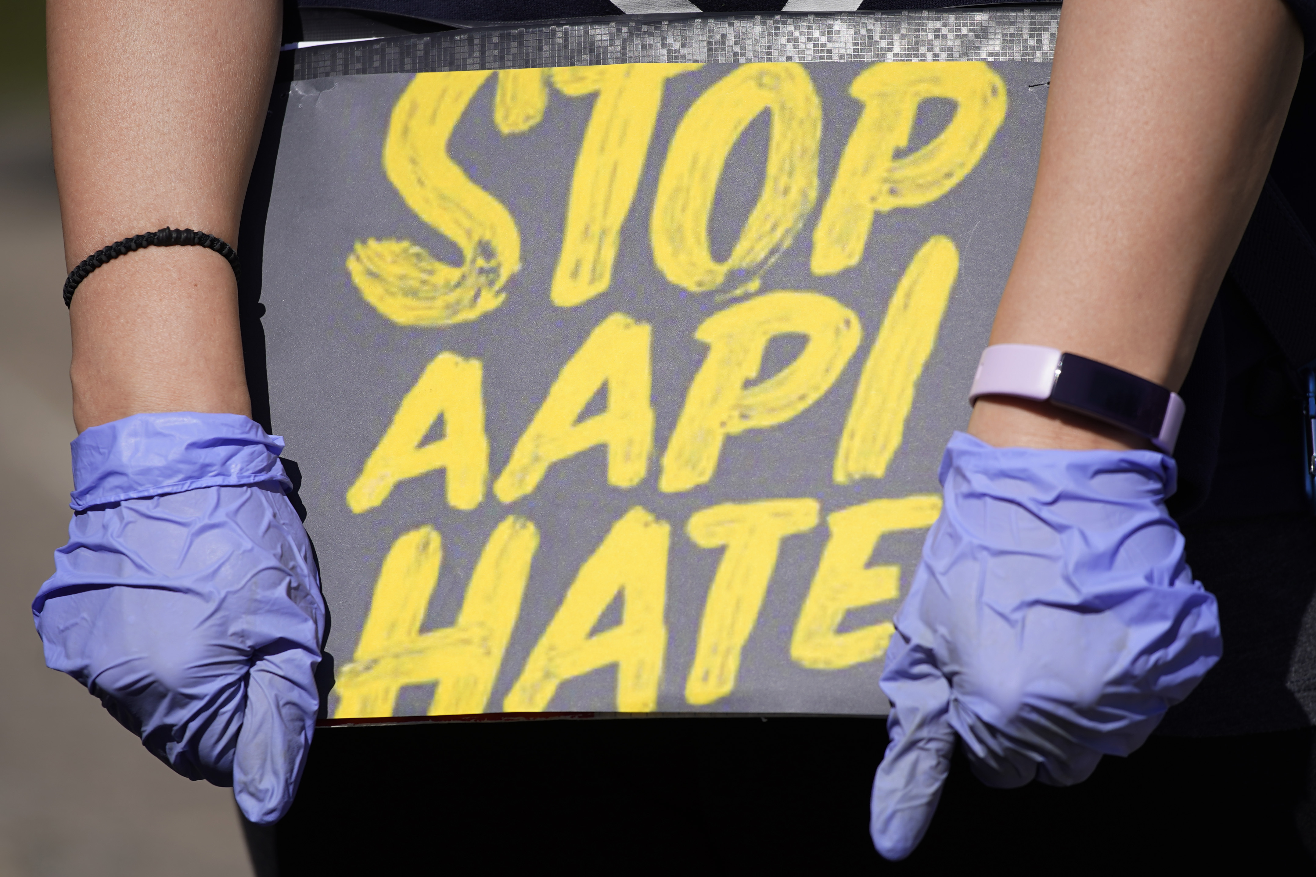 ILE - In this March 20, 2021, file photo, woman holds a sign and attends a rally to support stop AAPI (Asian Americans and Pacific Islanders) hate at the Logan Square Monument in Chicago. After more than a year filled with attacks on Asian Americans unfairly blamed for the coronavirus, a majority of Americans across racial and ethnic groups believe anti-Asian American discrimination has worsened over the last year. A poll from the The Associated Press-NORC Center for Public Affairs Research finds nearly half of Americans believe Asian Americans encounter "a great deal" or "quite a lot" of discrimination. (AP Photo/Nam Y. Huh, File)