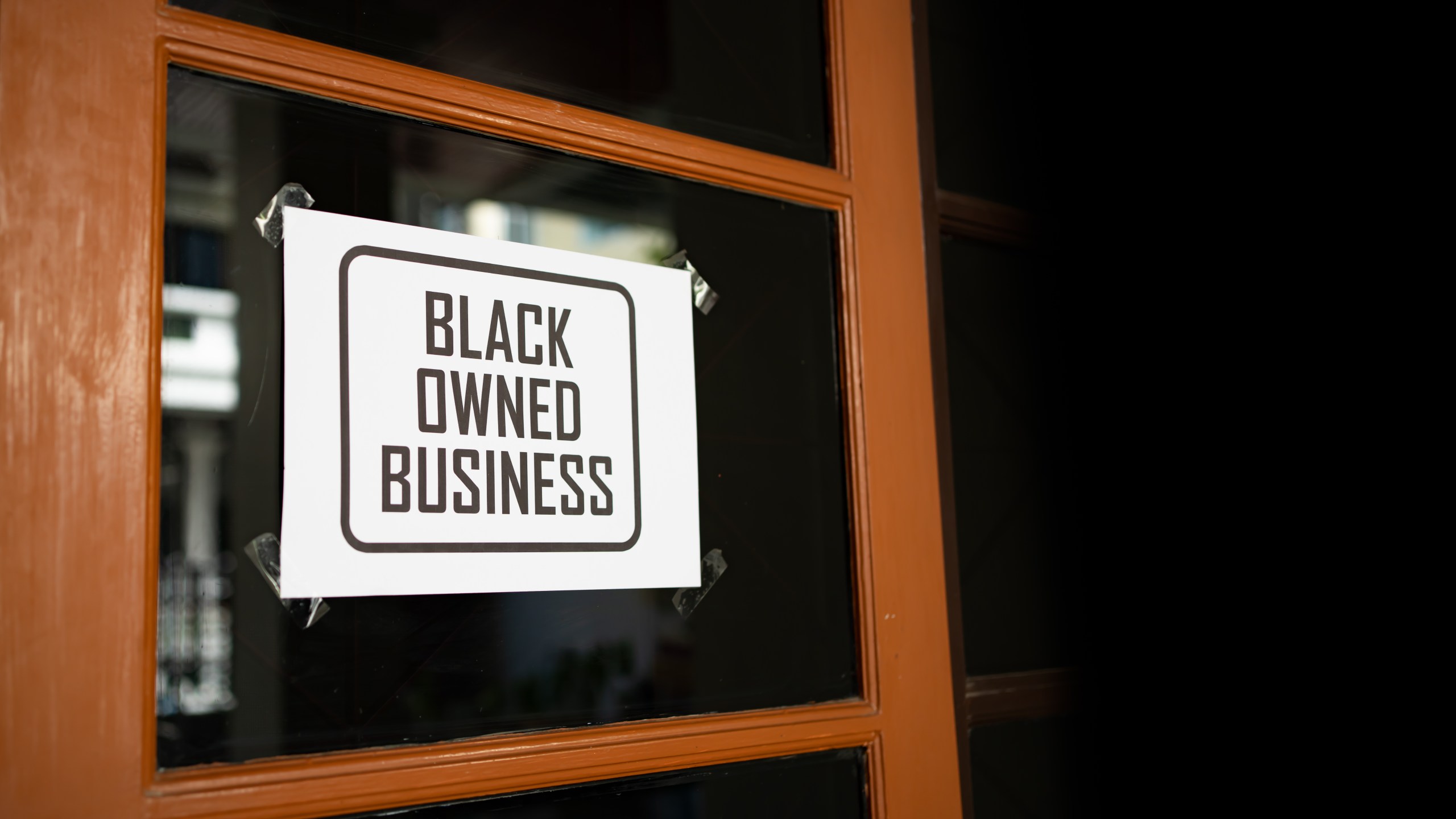 black business month sign was attached on the window (Getty Images)