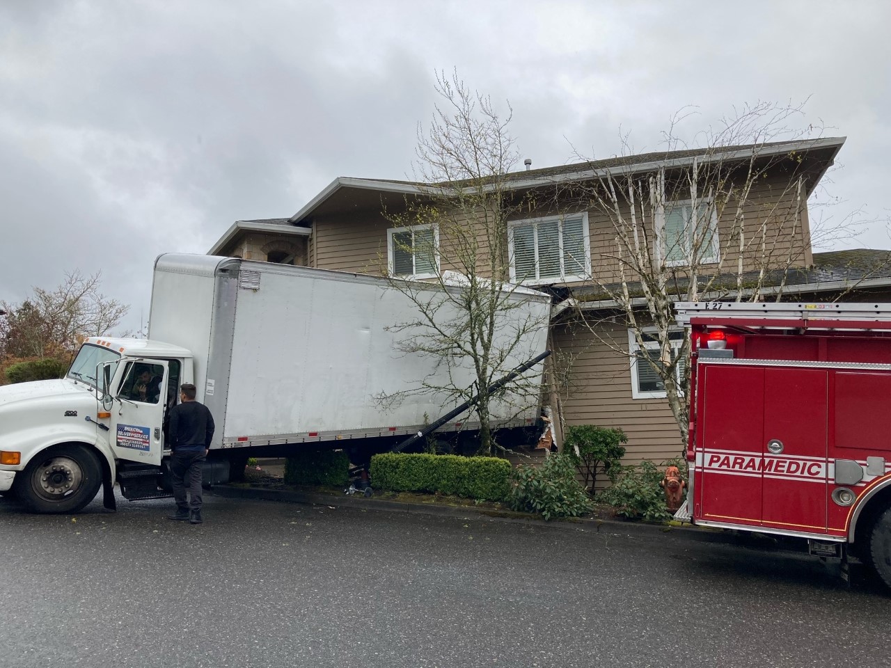 A box truck crashed into a house in northwest Portland while a person was inside on Tuesday afternoon, Portland Fire & Rescue said.