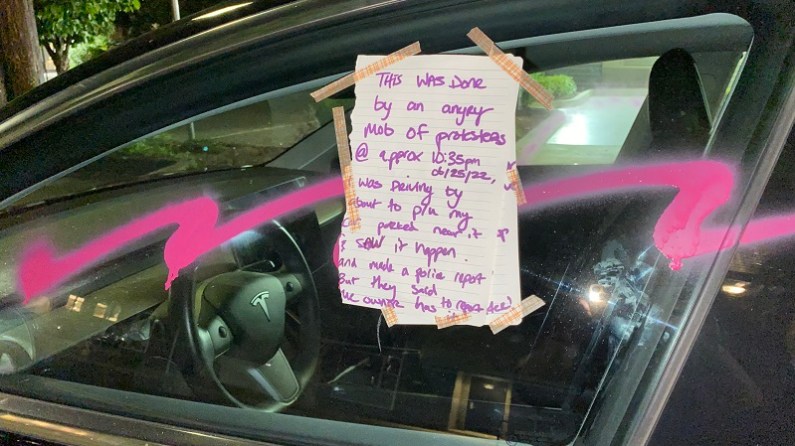 A group of protesters marched down Sandy Boulevard in Portland and vandalized businesses and damaged this Tesla, June 25, 2022 (KOIN)