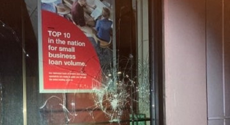 Vandals smashed windows and damaged an ATM at a bank in the 3800 block of NE Broadway in Portland during a destructive march from Grant Park, June 25, 2022 (PPB)