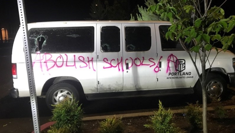 Vandals smashed windows and spray painted graffiti at Grant High School in Portland during a destructive march from Grant Park, June 25, 2022 (PPB)