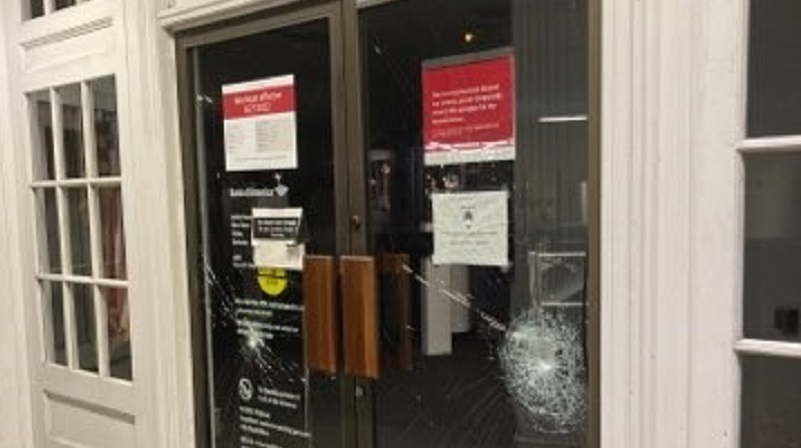 Vandals smashed windows and damaged an ATM at a bank in the 3800 block of NE Broadway in Portland during a destructive march from Grant Park, June 25, 2022 (PPB)