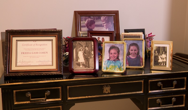 Pictures of her family through the years grace a desk at the Portland home of Frieda Cohen, July 25, 2022 (KOIN)