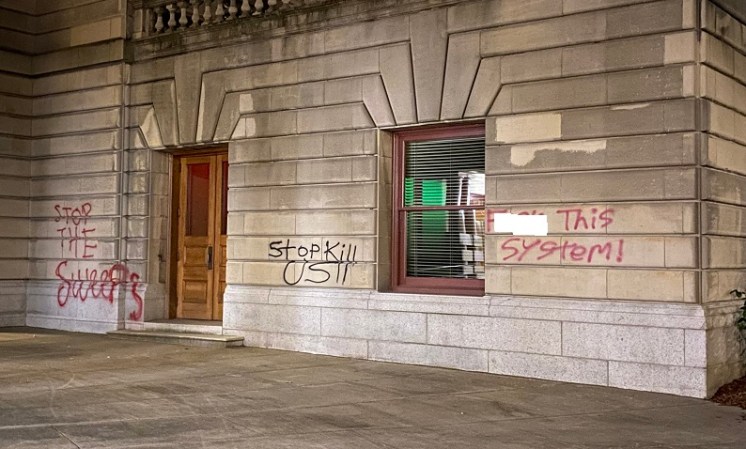 Dozens of protesters marched through the streets of downtown Portland and smashed windows at multiple businesses while tagging businesses and buildings such as City Hall, July 4, 2022 (KOIN)