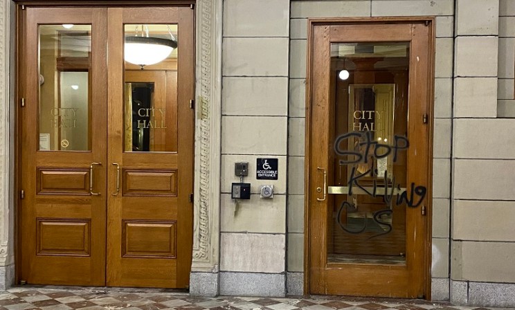 Dozens of protesters marched through the streets of downtown Portland and smashed windows at multiple businesses while tagging businesses and buildings such as City Hall, July 4, 2022 (KOIN)