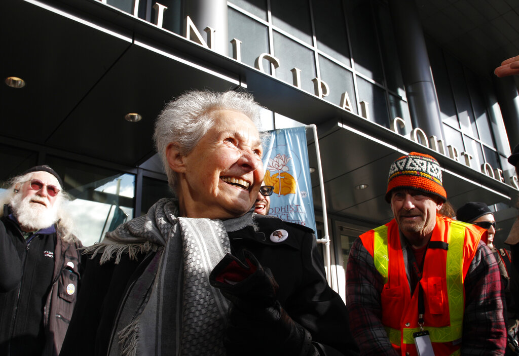 Dorli Rainey, 84, center, who was pepper-sprayed by police while taking part in an "Occupy Seattle" protest, smiles before speaking on Nov. 18, 2011, in front of police headquarters in downtown Seattle. (AP Photo/Ted S. Warren, File)