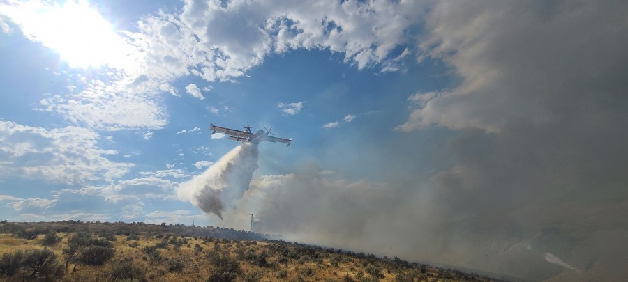 Crews fight the Vantage Highway Fire from the air as it expands north on Tuesday, August 2, 2022