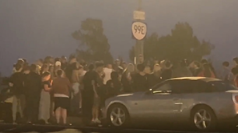 About 100 people gathered for a vigil near I-5 and MLK Boulevard for a young man who died during a street racing takeover in Portland, August 29, 2022 (KOIN)