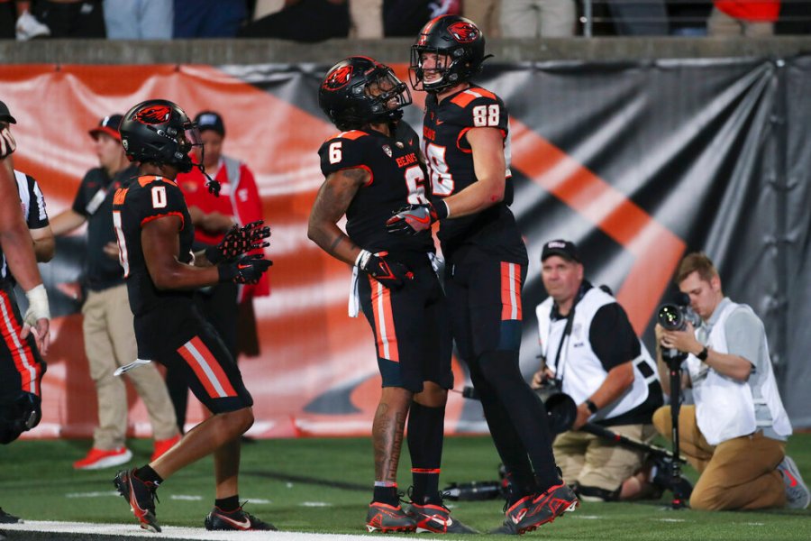 Oregon State tight end Luke Musgrave (88) celebrates his touchdown with Damien Martinez (6) and Tre'Shaun Harrison (0) during the first half of the team's NCAA college football game against Boise State on Saturday, Sept. 3, 2022, in Corvallis, Ore. (AP Photo/Amanda Loman)