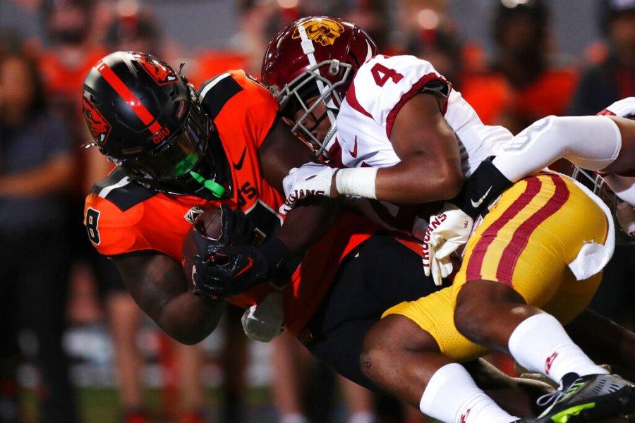 Oregon State running back Jam Griffin is brought down by Southern California defensive back Max Williams during the first half of an NCAA college football game Saturday, Sept. 24, 2022, in Corvallis, Ore. (AP Photo/Amanda Loman)