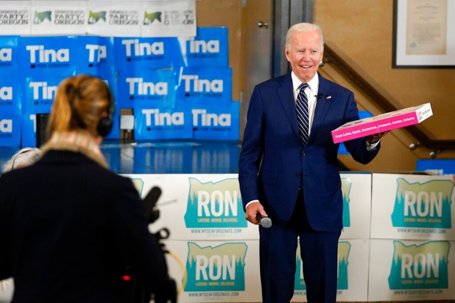 President Joe Biden holds a box of doughnuts during a grassroots volunteer event with the Oregon Democrats at the SEIU Local 49 in Portland, Ore. Friday, Oct. 14, 2022. (AP Photo/Carolyn Kaster)