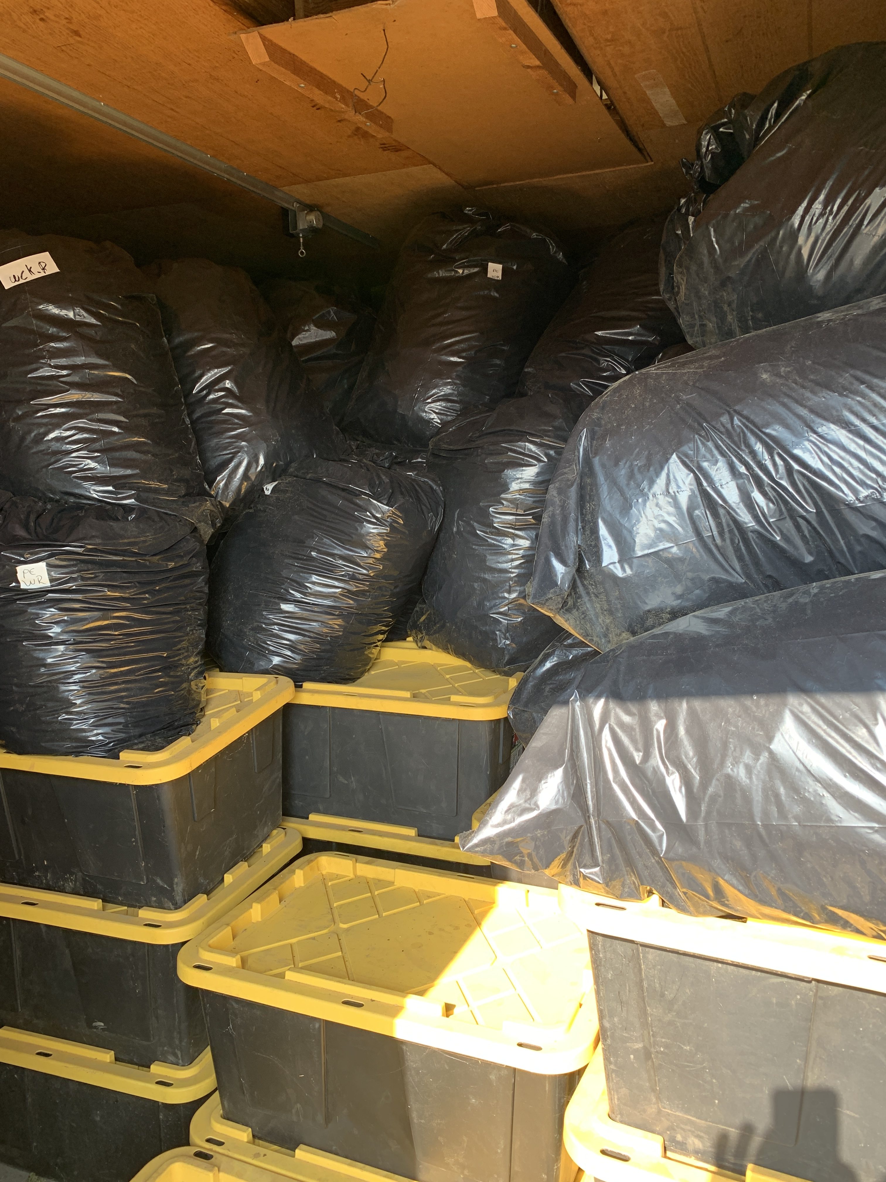 Bins and bags filled with illegally grown marijuana stacked from floor to ceiling at a Newberg, Oregon property on Oct. 18, 2022. (Credit: Yamhill County Sheriff's Office)
