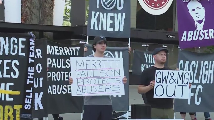 Fans outside Providence Park hold signs calling for Timbers/Thorns owner Merrit Paulson to sell the team after an investigation by the NWSL, October 3, 2022 (KOIN)