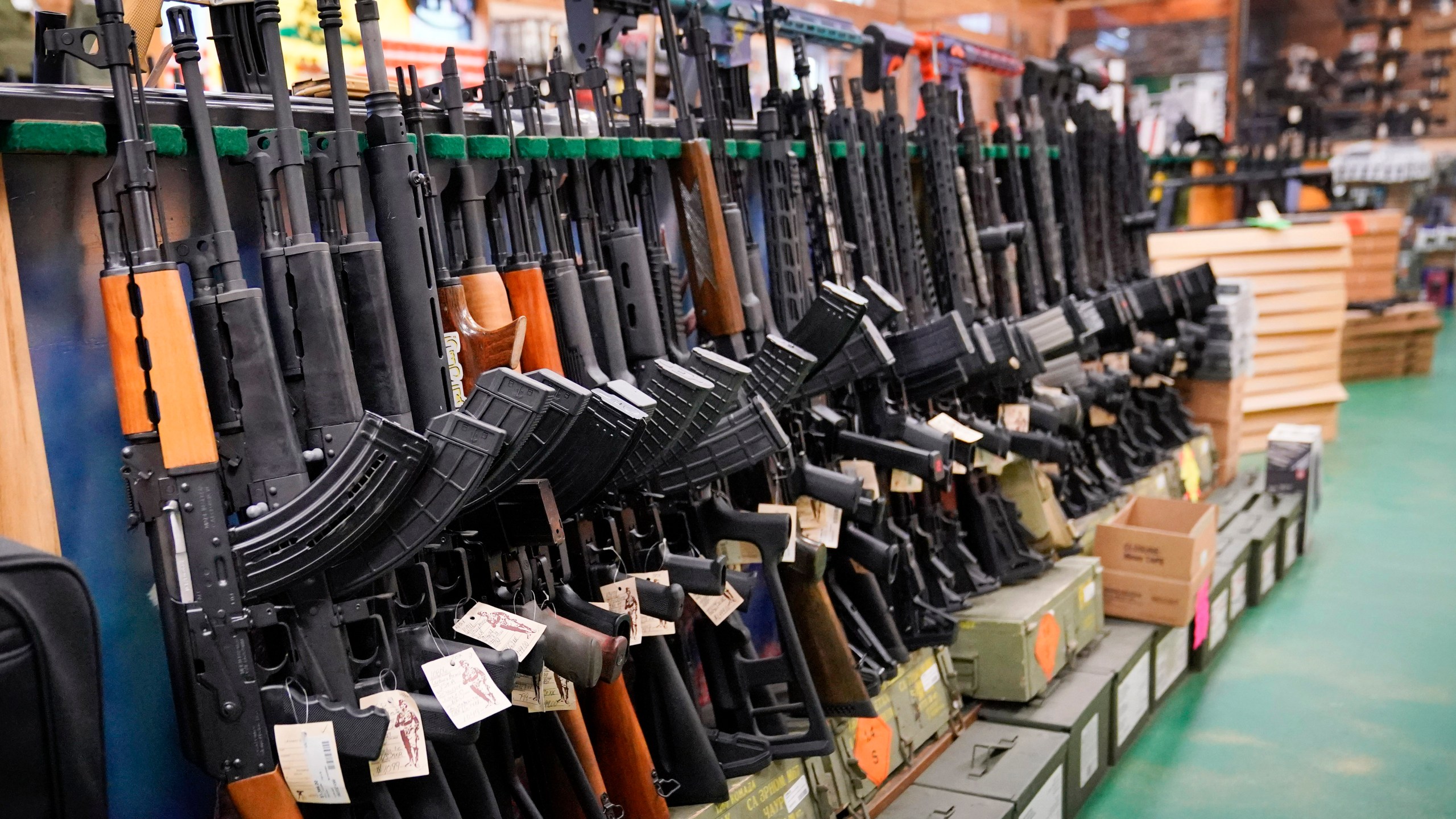 Assault rifles are displayed at Coastal Trading and Pawn, Monday, July 18, 2022, in Auburn, Maine. (AP Photo/Robert F. Bukaty, File)