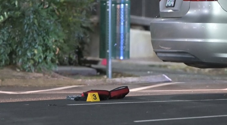 An evidence marker on the ground near an armed robbery and officer-involved shooting in Southeast Portland, November 19, 2022 (KOIN)