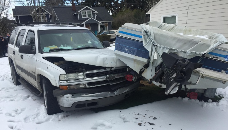 Travis Hendon was arrested after crashing his SUV into this parked boat in Portland, 2021 (PPB)