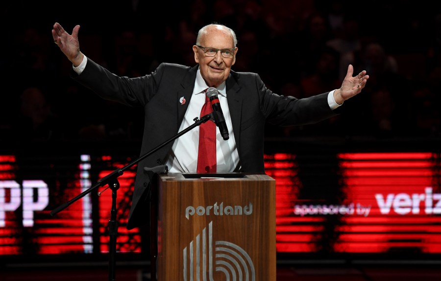 Former radio announcer for the Portland Trail Blazers Bill Schonely reacts to the fans as he is honored during halftime against the Utah Jazz in Portland, Sunday, April 10, 2022. (AP Photo/Steve Dykes)