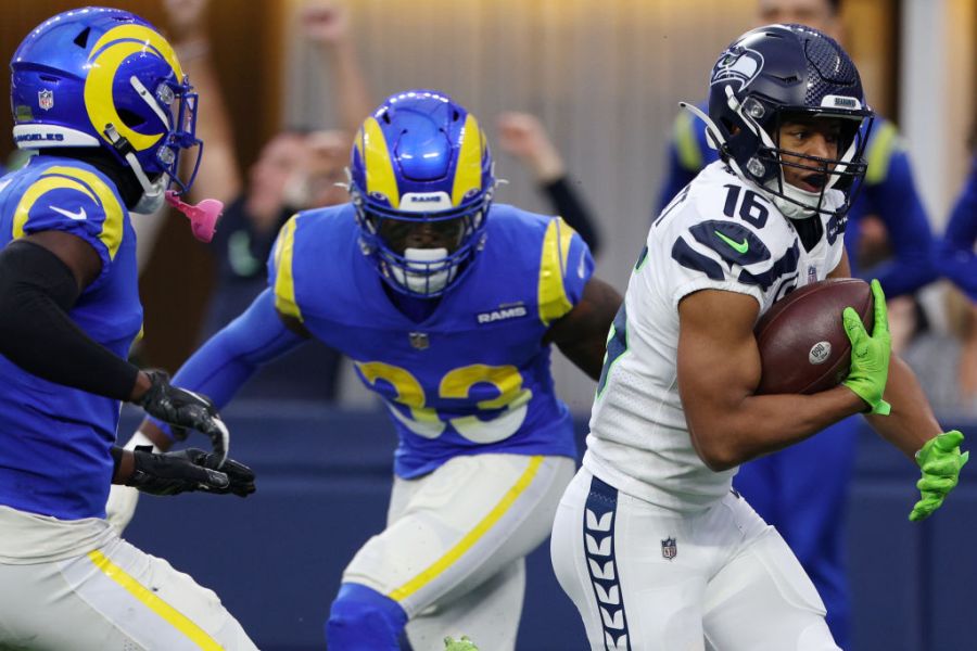 Tyler Lockett #16 of the Seattle Seahawks rushes past Nick Scott #33 of the Los Angeles Rams and Derion Kendrick #6 to score a touchdown during the first quarter of the game at SoFi Stadium on December 04, 2022 in Inglewood, California. (Photo by Harry How/Getty Images)