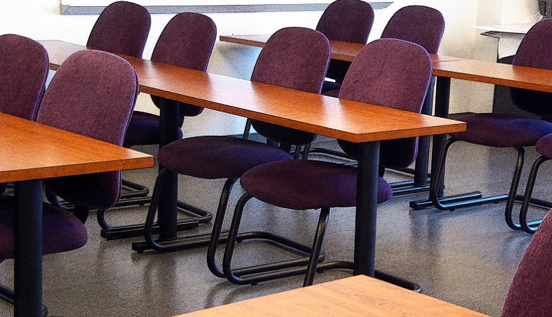 A classroom with tables and chairs (Public Domain Photos/Linneaea Mallette)