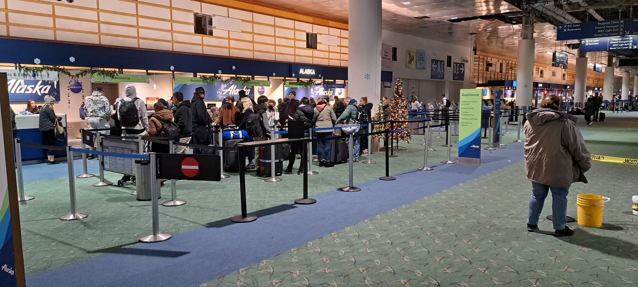 Travelers waiting in line for Alaska Airlines at Portland International Airport on Friday, Dec. 23, 2022