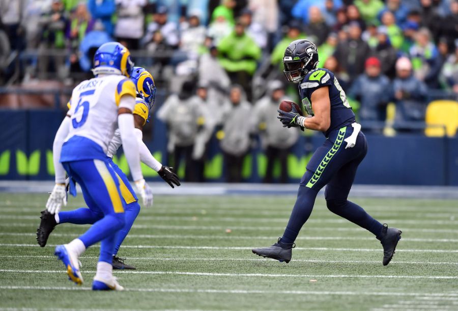 Noah Fant #87 of the Seattle Seahawks runs with the ball after a catch during the first quarter against the Los Angeles Rams at Lumen Field on January 08, 2023 in Seattle, Washington. (Photo by Jane Gershovich/Getty Images)