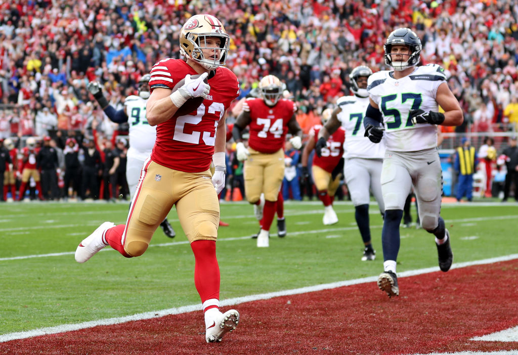 Christian McCaffrey #23 of the San Francisco 49ers celebrates after scoring a 3 yard touchdown against the Seattle Seahawks during the first quarter in the NFC Wild Card playoff game at Levi's Stadium on January 14, 2023 in Santa Clara, California. (Photo by Ezra Shaw/Getty Images)