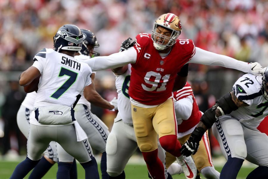 Arik Armstead #91 of the San Francisco 49ers sacks Geno Smith #7 of the Seattle Seahawks during the first quarter in the NFC Wild Card playoff game at Levi's Stadium on January 14, 2023 in Santa Clara, California. (Photo by Ezra Shaw/Getty Images)