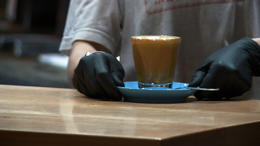 A barista serves a cup of coffee at Proud Mary Coffee Roasters in Portland on Feb. 7, 2023. (KOIN)