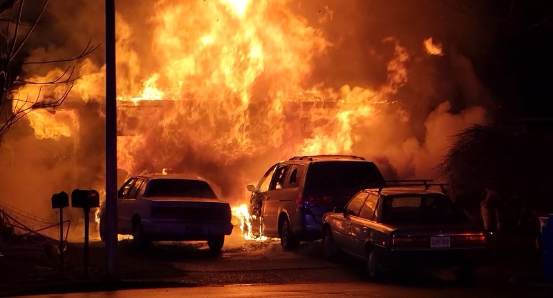 A fire that began in the garage at 10943 SE Ankeny in Portland spread to the home and cars, February 4, 2023 (KOIN)