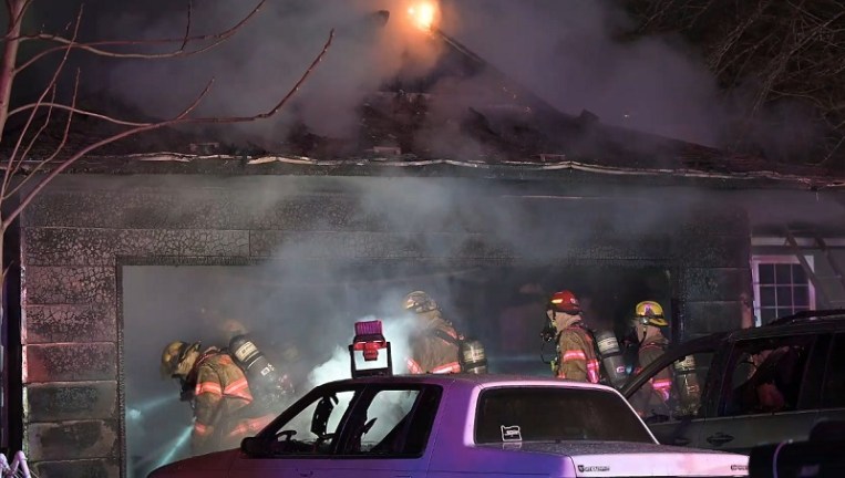 A fire that began in the garage at 10943 SE Ankeny in Portland spread to the home and cars, February 4, 2023 (KOIN)