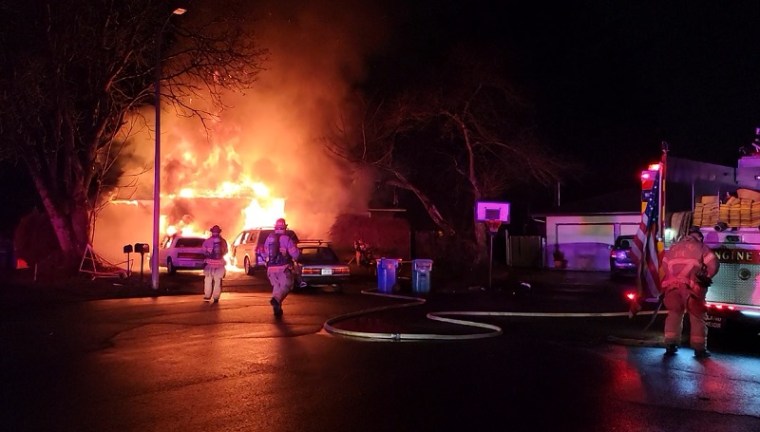 A fire that began in the garage at 10943 SE Ankeny in Portland spread to the home and cars, February 4, 2023 (KOIN)