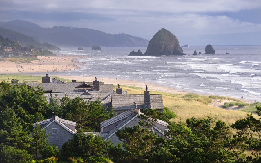 Haystack Rock seen in the distance in Cannon Beach, Oregon. (Credit: Getty Images)