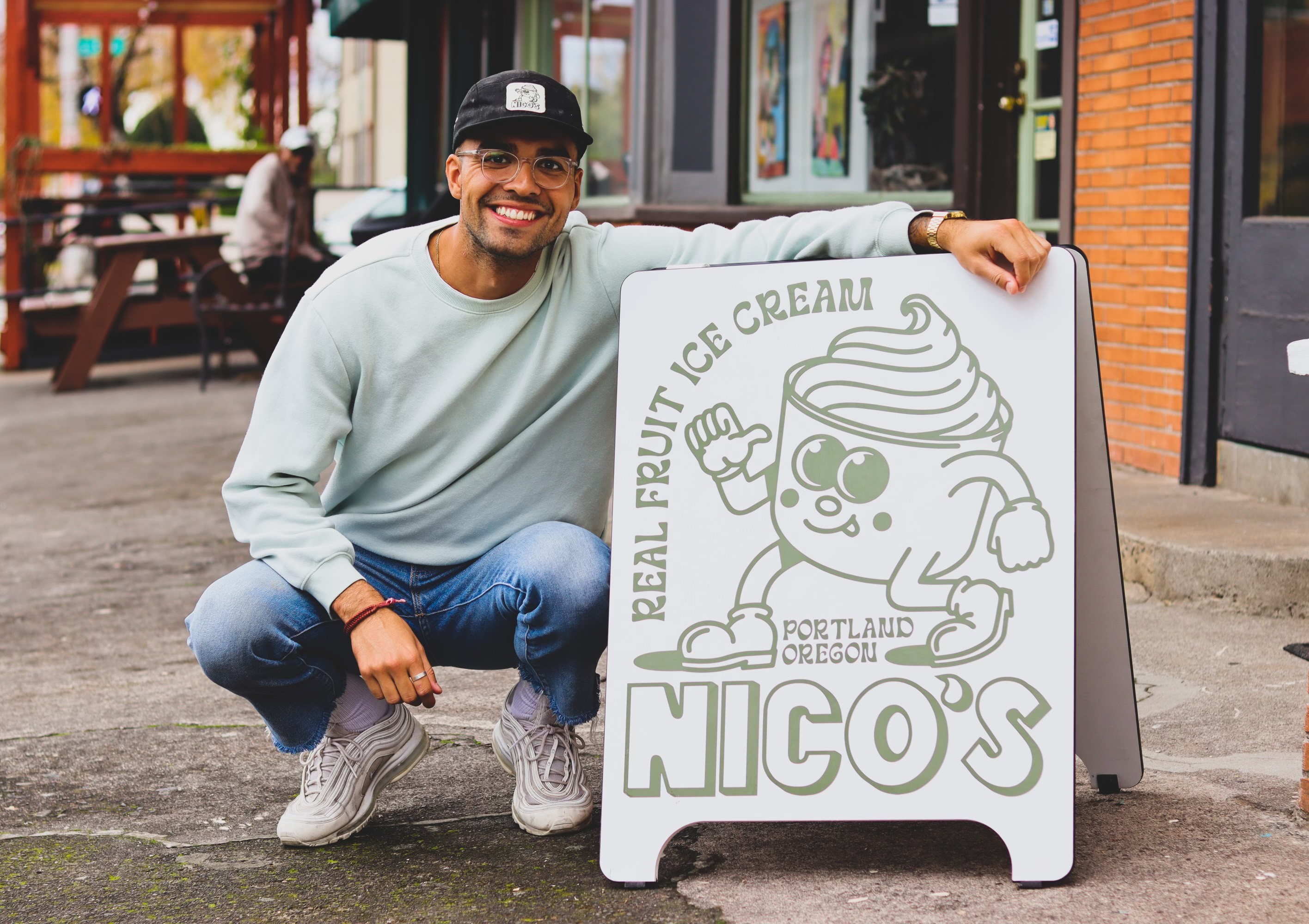 Nico Vergara poses next to a sign outside a Nico's Ice Cream shop in Portland. Photo courtesy Nico Vergara