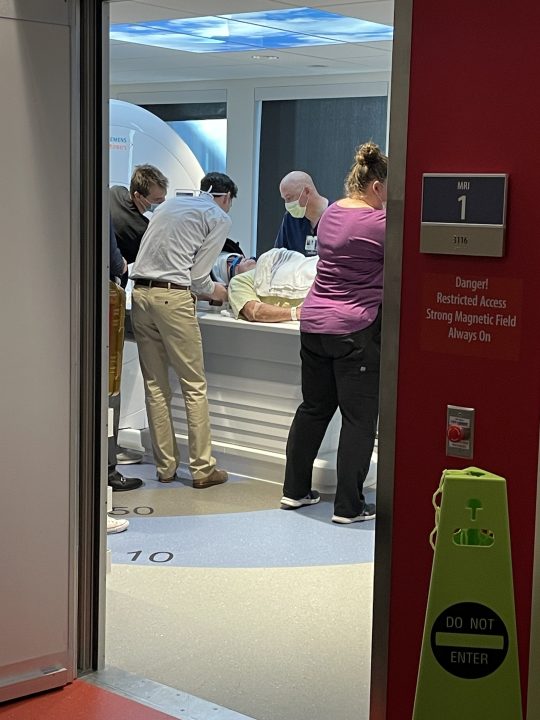 Rick Cranston lies down as medical staff fit his head frame to the MRI machine at OHSU. (KOIN)