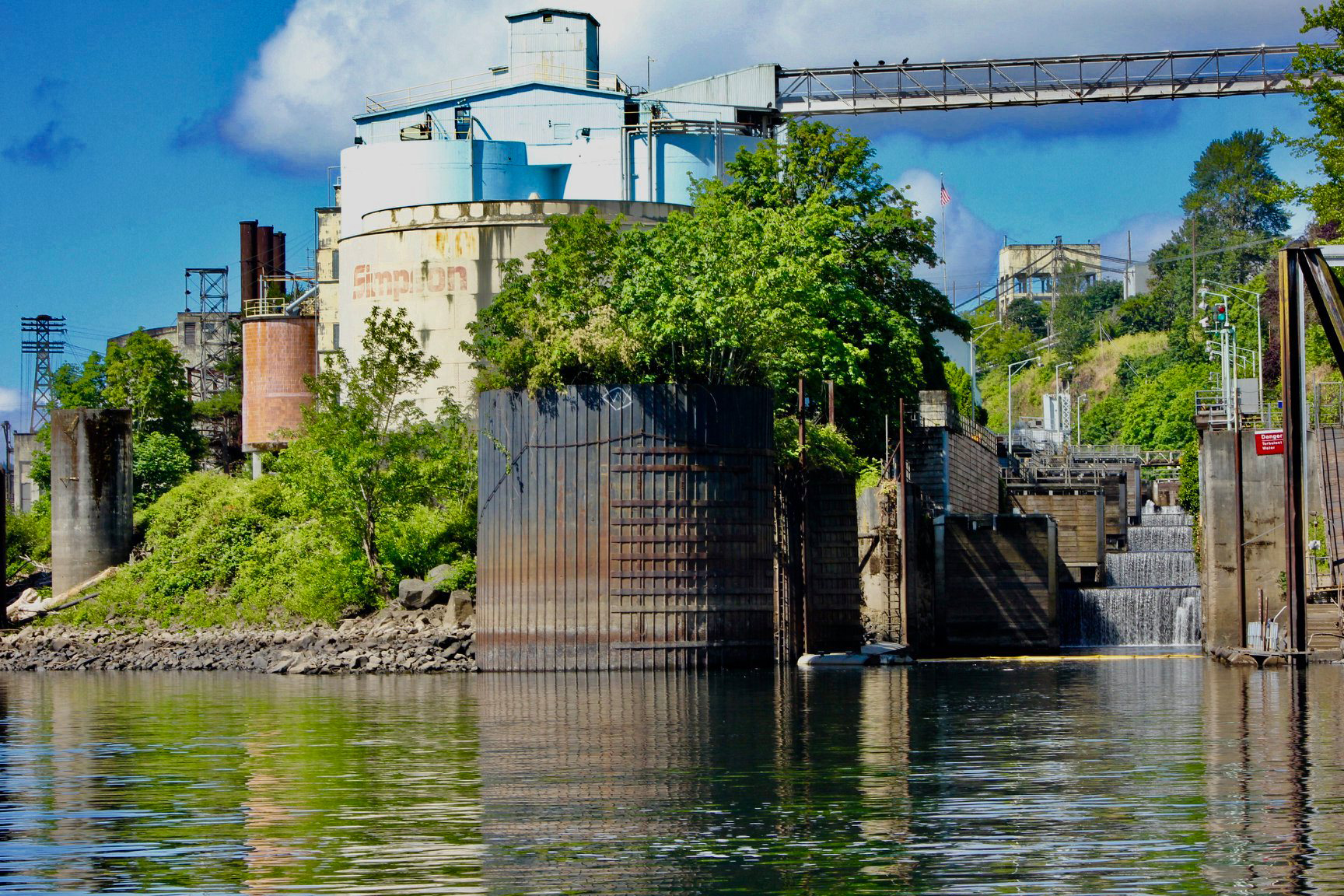 The U.S. Army Corps of Engineers’ Portland District (Corps) will move forward this spring with a two-year safety and seismic repair project at Willamette Falls Locks ahead of the agency’s official transfer of the historic navigation lock system to the Willamette Falls Locks Authority, expected to take place in 2026. This image, from June 2019, offers a view from just downstream of the four-lock system, located at Willamette Falls between West Linn and Oregon City. Photo courtesy U.S. Army Corps of Engineers