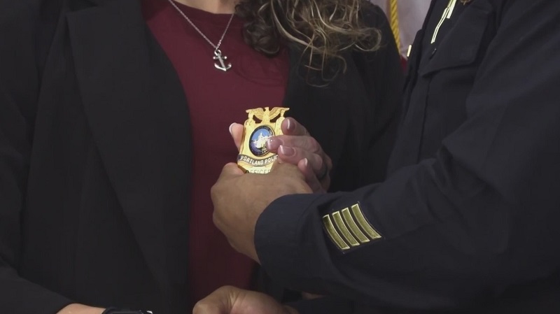 A new Portland Police Bureau officer receives her badge (PPB, file)